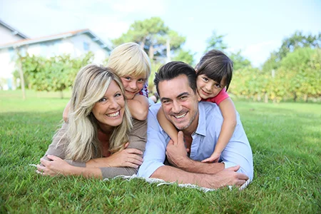 family laying in grass