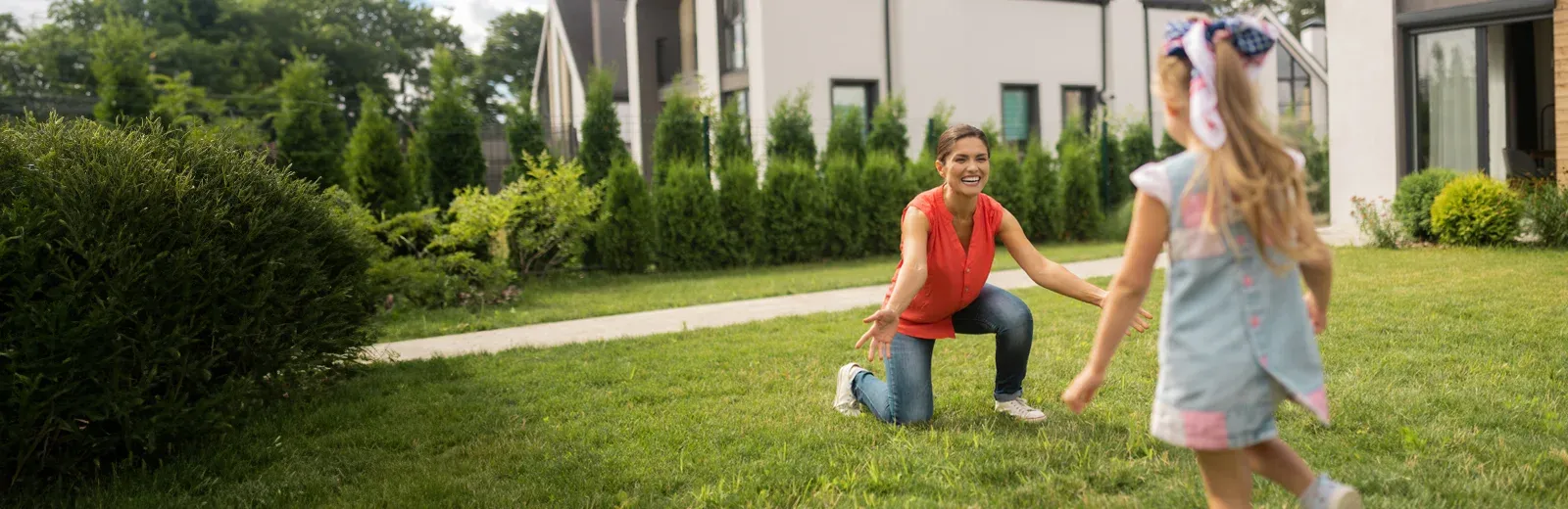 mother and daughter playing outside mosquito and tick free lawn