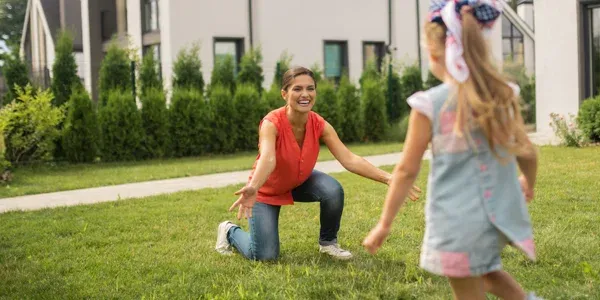 mom and daughter playing in front lawn